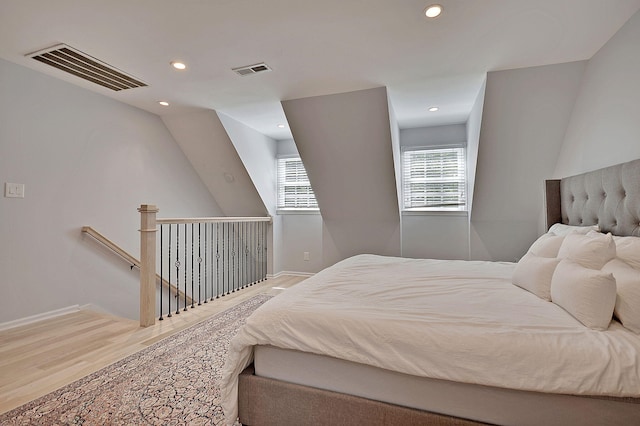 bedroom featuring recessed lighting, visible vents, baseboards, and wood finished floors