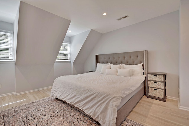 bedroom with light wood finished floors, baseboards, visible vents, and recessed lighting