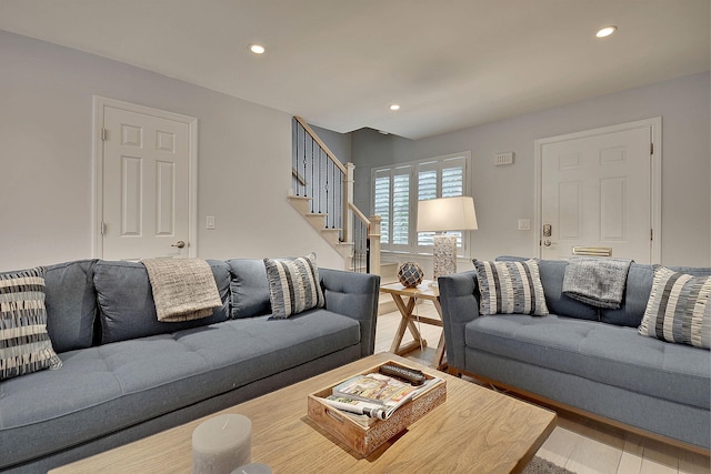 living room with light wood-style flooring, stairway, and recessed lighting