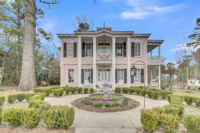 neoclassical home with a balcony