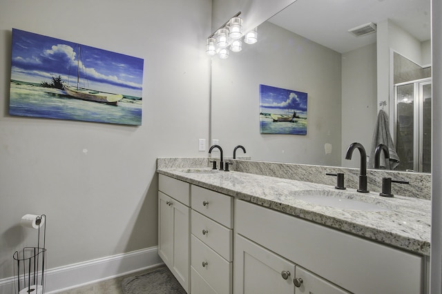 full bathroom with double vanity, visible vents, a stall shower, and a sink
