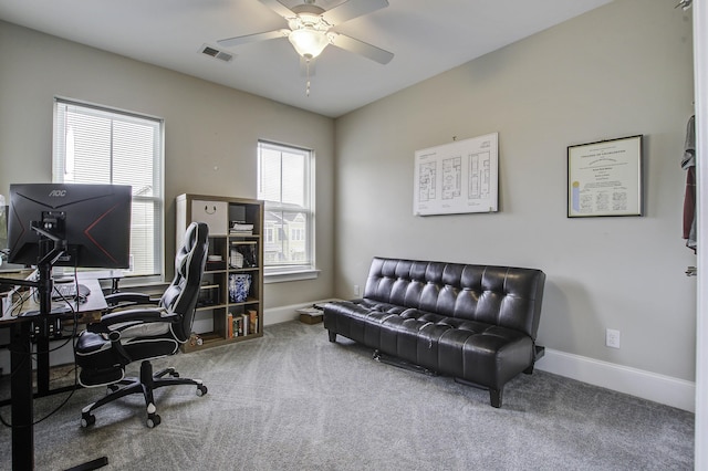 office area featuring visible vents, carpet flooring, baseboards, and a ceiling fan
