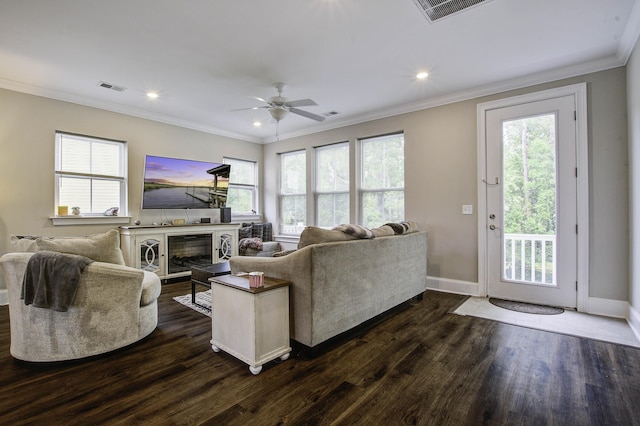living room featuring dark wood finished floors, visible vents, baseboards, and a healthy amount of sunlight