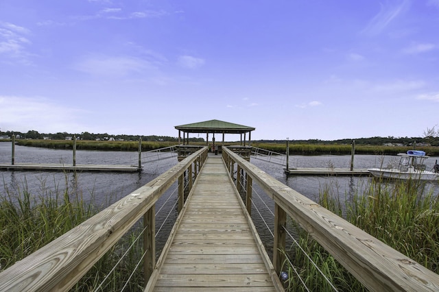 view of dock featuring a gazebo and a water view