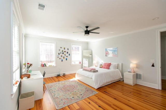 bedroom with crown molding, ceiling fan, and light wood-type flooring