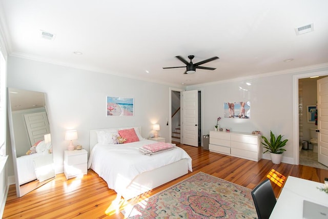 bedroom featuring ornamental molding, light hardwood / wood-style floors, and ceiling fan