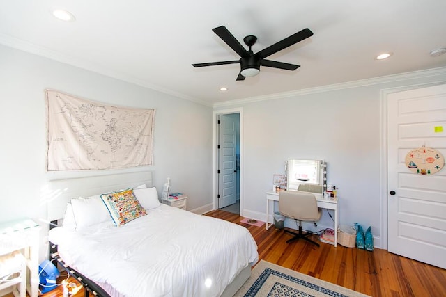 bedroom featuring hardwood / wood-style floors, ornamental molding, and ceiling fan