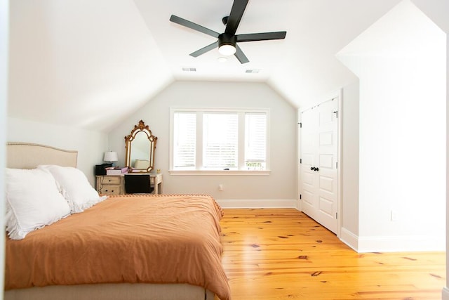 bedroom with wood-type flooring, ceiling fan, and vaulted ceiling