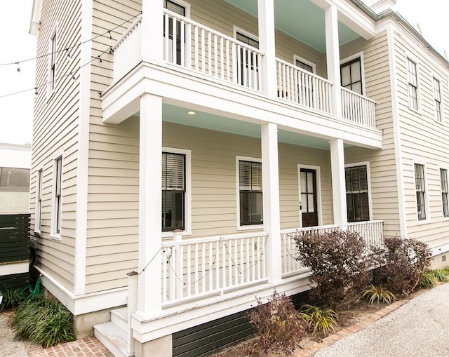 view of home's exterior featuring a balcony and covered porch