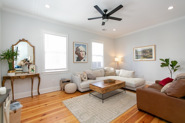 living room featuring crown molding, ceiling fan, and wood-type flooring