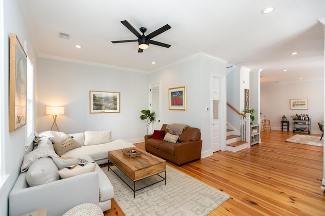 living room with crown molding, ceiling fan, and light hardwood / wood-style floors