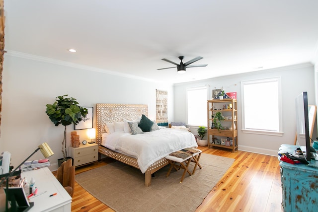 bedroom featuring crown molding, light hardwood / wood-style floors, and ceiling fan