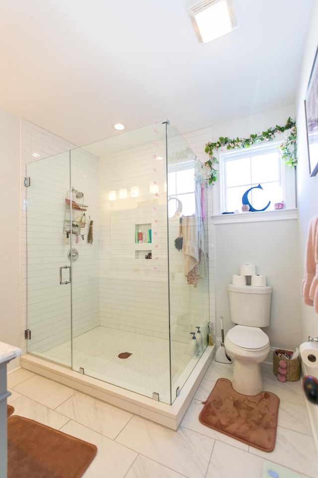 bathroom with tile patterned floors, a shower with door, and toilet