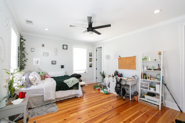 bedroom featuring crown molding, ceiling fan, and hardwood / wood-style floors