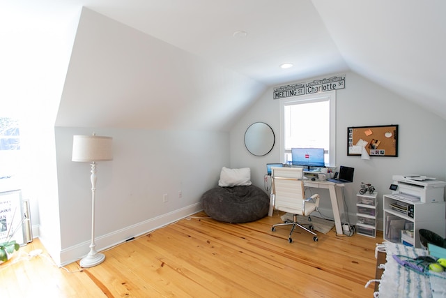 office with lofted ceiling and light wood-type flooring