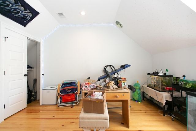 interior space with lofted ceiling and light wood-type flooring