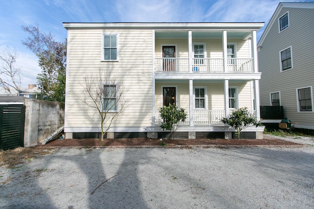 view of front of home featuring a balcony and covered porch