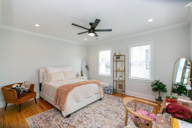 bedroom with crown molding, ceiling fan, and light hardwood / wood-style floors