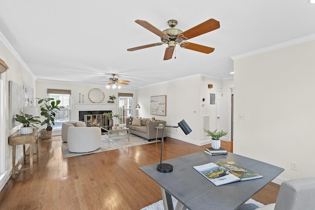 dining space with hardwood / wood-style floors, ceiling fan, and crown molding