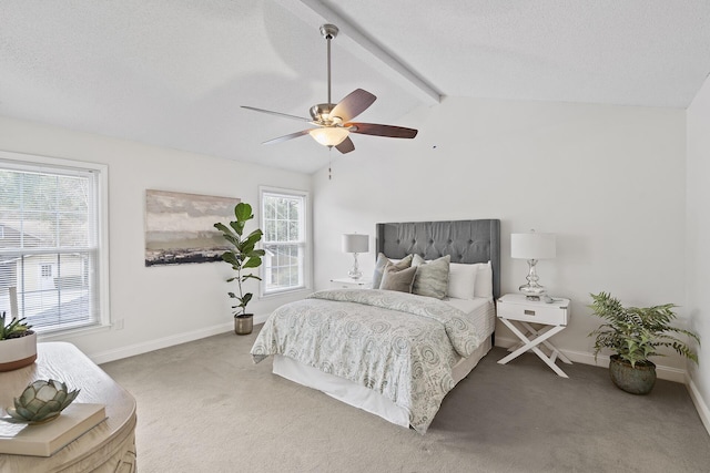 bedroom featuring multiple windows, ceiling fan, carpet floors, and lofted ceiling with beams