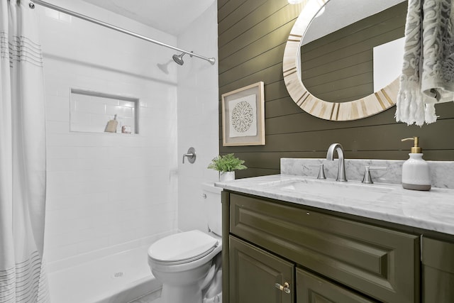 bathroom featuring vanity, curtained shower, toilet, and wooden walls