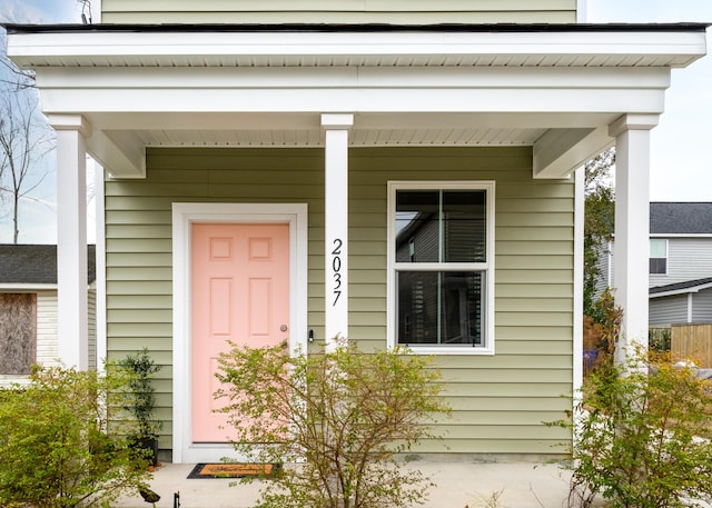 view of exterior entry with a porch