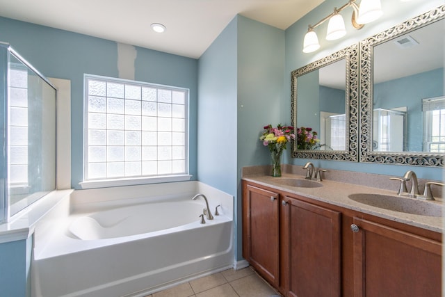 bathroom featuring tile patterned flooring, vanity, and shower with separate bathtub