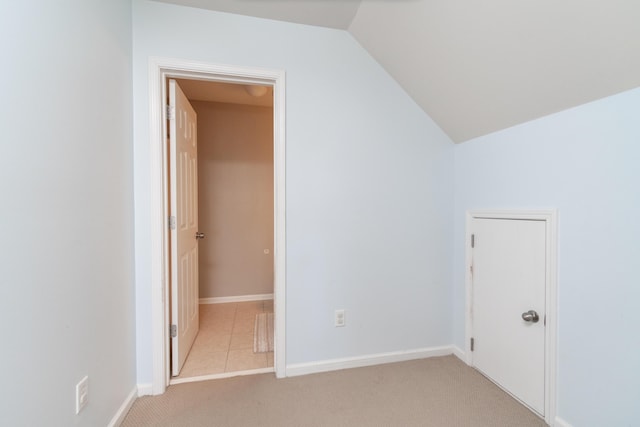 interior space with lofted ceiling and light colored carpet