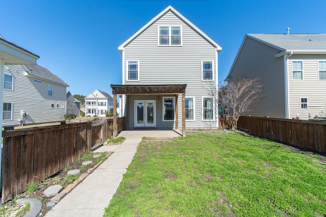 back of house featuring french doors, a yard, and a patio