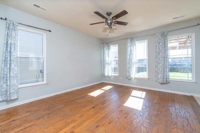 unfurnished room with hardwood / wood-style flooring and ceiling fan