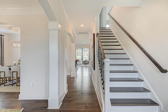 stairs with visible vents, arched walkways, baseboards, hardwood / wood-style flooring, and recessed lighting