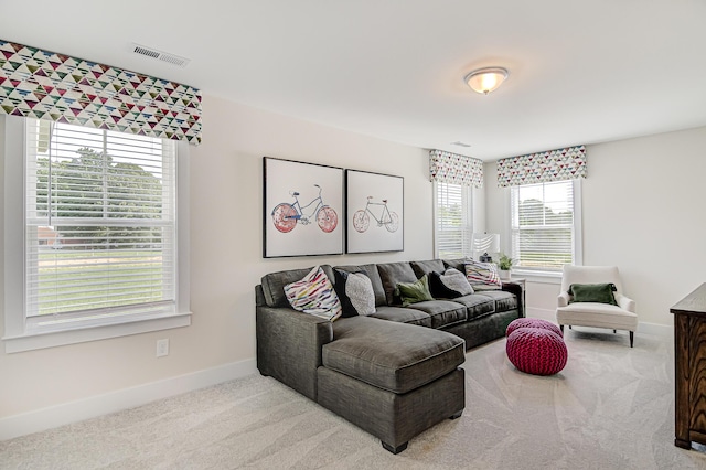 carpeted living room featuring visible vents and baseboards