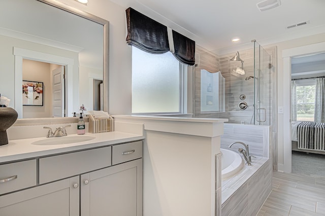 ensuite bathroom with a shower stall, visible vents, a bath, and vanity