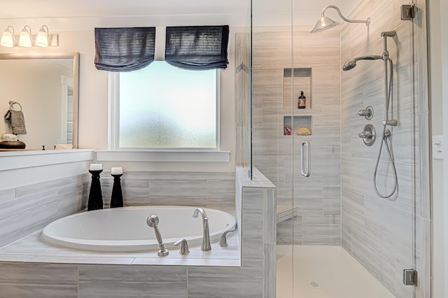 full bathroom featuring a garden tub and a shower stall