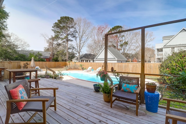 deck with a fenced backyard and a fenced in pool