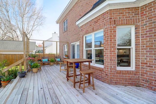 deck with fence and an outdoor living space