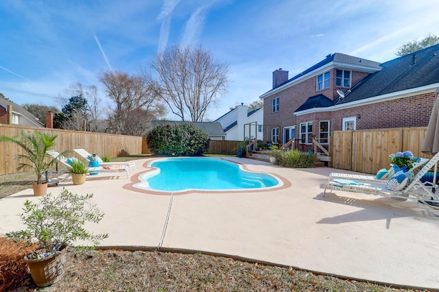 view of swimming pool featuring a patio area, a fenced backyard, a deck, and a fenced in pool