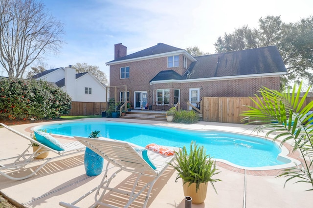 view of swimming pool featuring a deck, a patio, a fenced backyard, and a fenced in pool