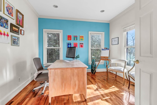 home office with light wood finished floors, ornamental molding, and baseboards