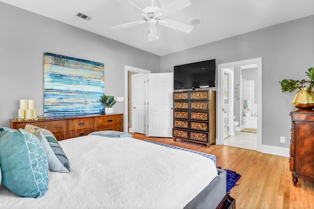 bedroom featuring ensuite bathroom, ceiling fan, visible vents, baseboards, and light wood-type flooring