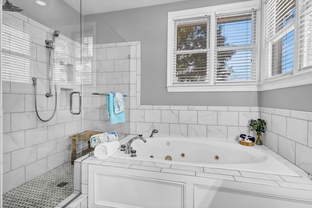 bathroom featuring a stall shower and a tub with jets