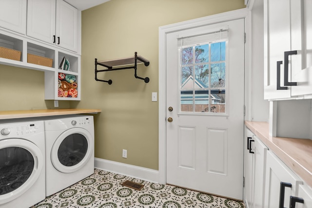 washroom featuring cabinet space, baseboards, separate washer and dryer, and tile patterned floors