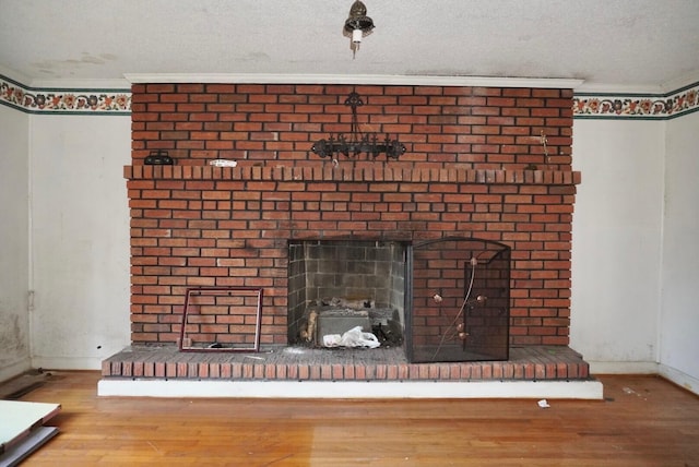 150 M L King Blvd, Saint Stephen, SC 29479 - detailed view of wood finished floors, a brick fireplace, baseboards, crown molding, and a textured ceiling