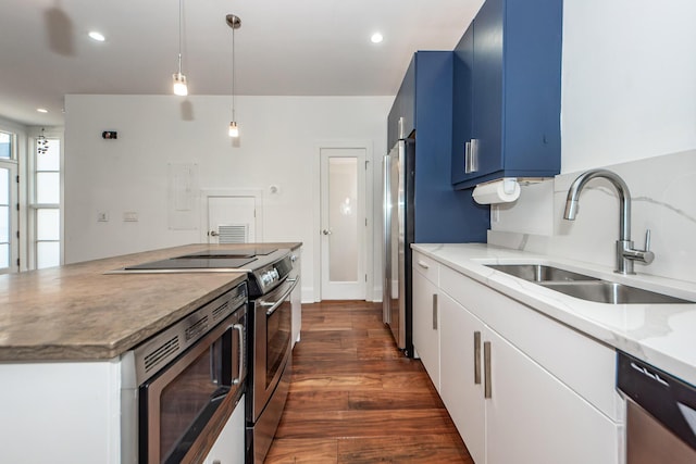 kitchen featuring sink, dark hardwood / wood-style floors, blue cabinetry, white cabinetry, and stainless steel appliances