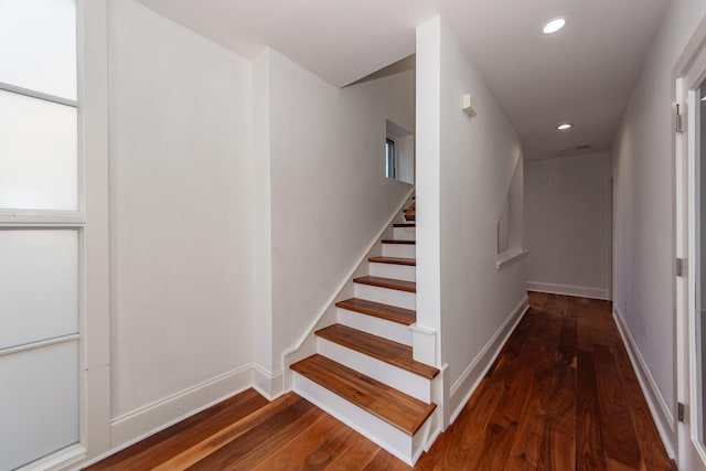 staircase with wood-type flooring