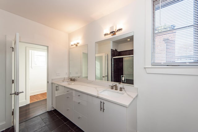 bathroom with a shower with door, vanity, and wood-type flooring