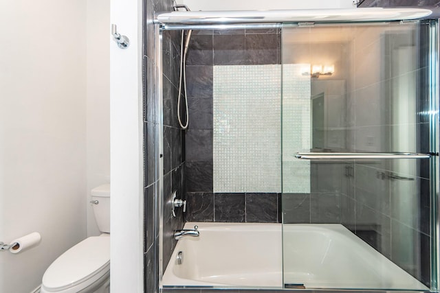 bathroom with toilet and bath / shower combo with glass door