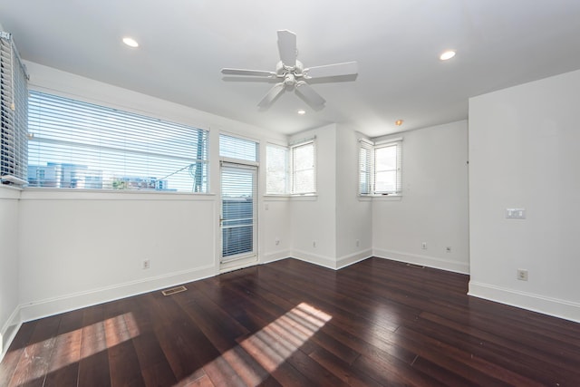 spare room featuring dark hardwood / wood-style floors and ceiling fan