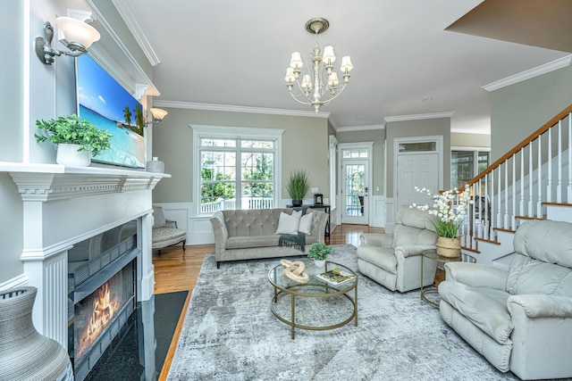 living room with an inviting chandelier, crown molding, and wood-type flooring