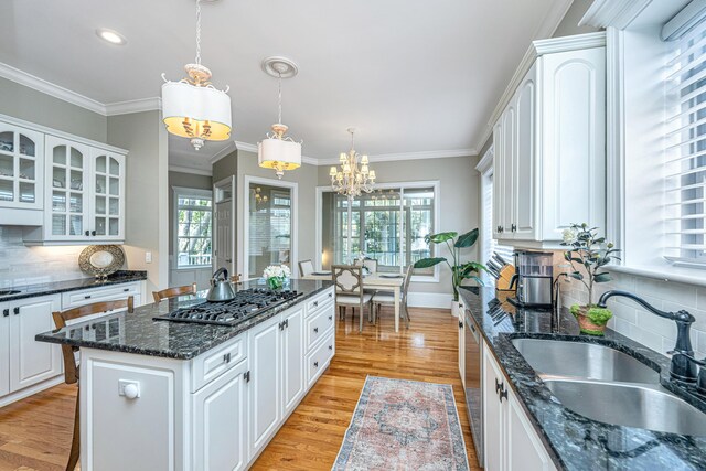 4233 Haulover Dr, Johns Island, SC 29455 - kitchen with a sink, a chandelier, stainless steel gas stovetop, healthy amount of natural light, and ornamental molding